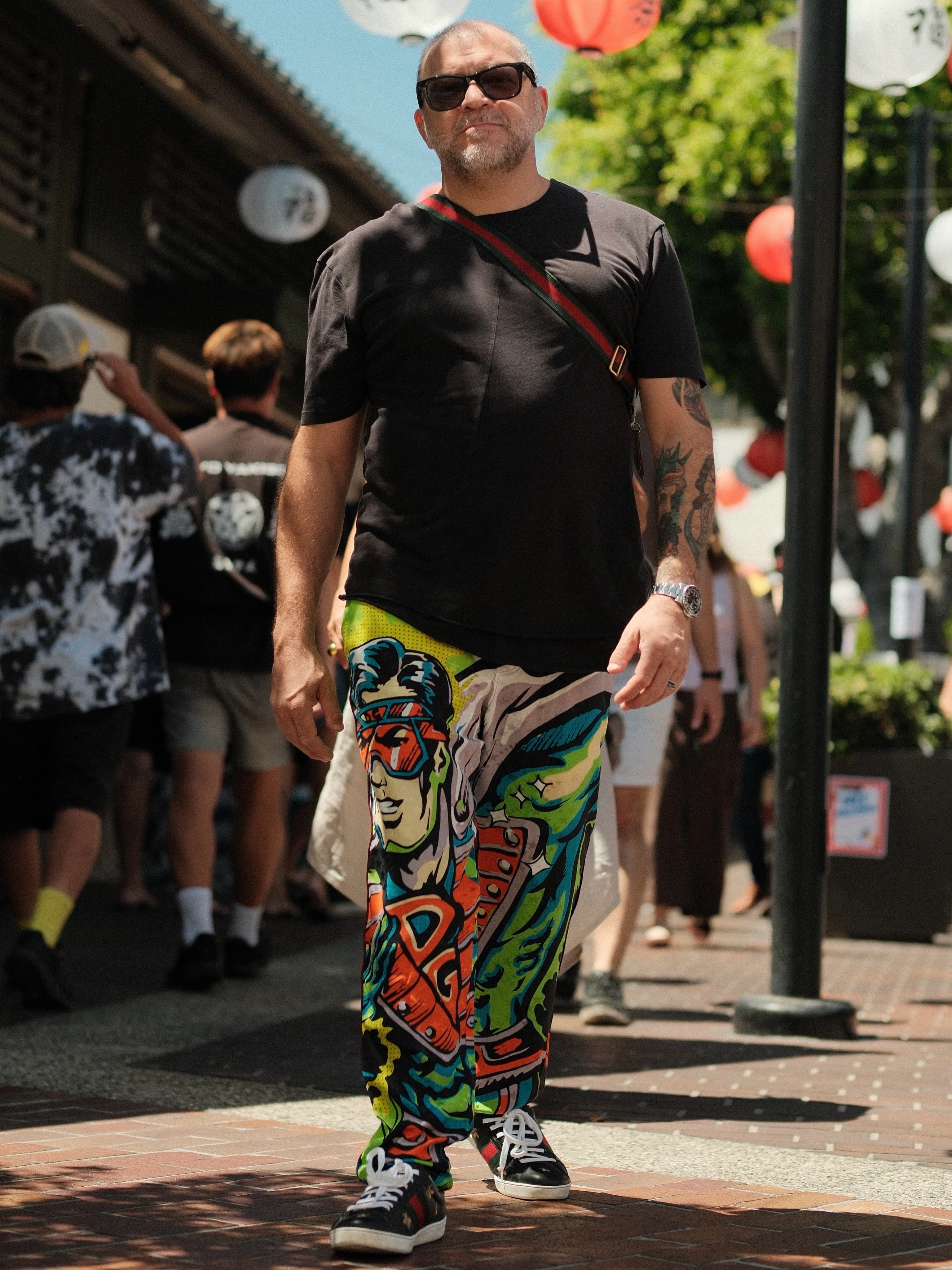 Plain black tee, loud graphic-print trousers