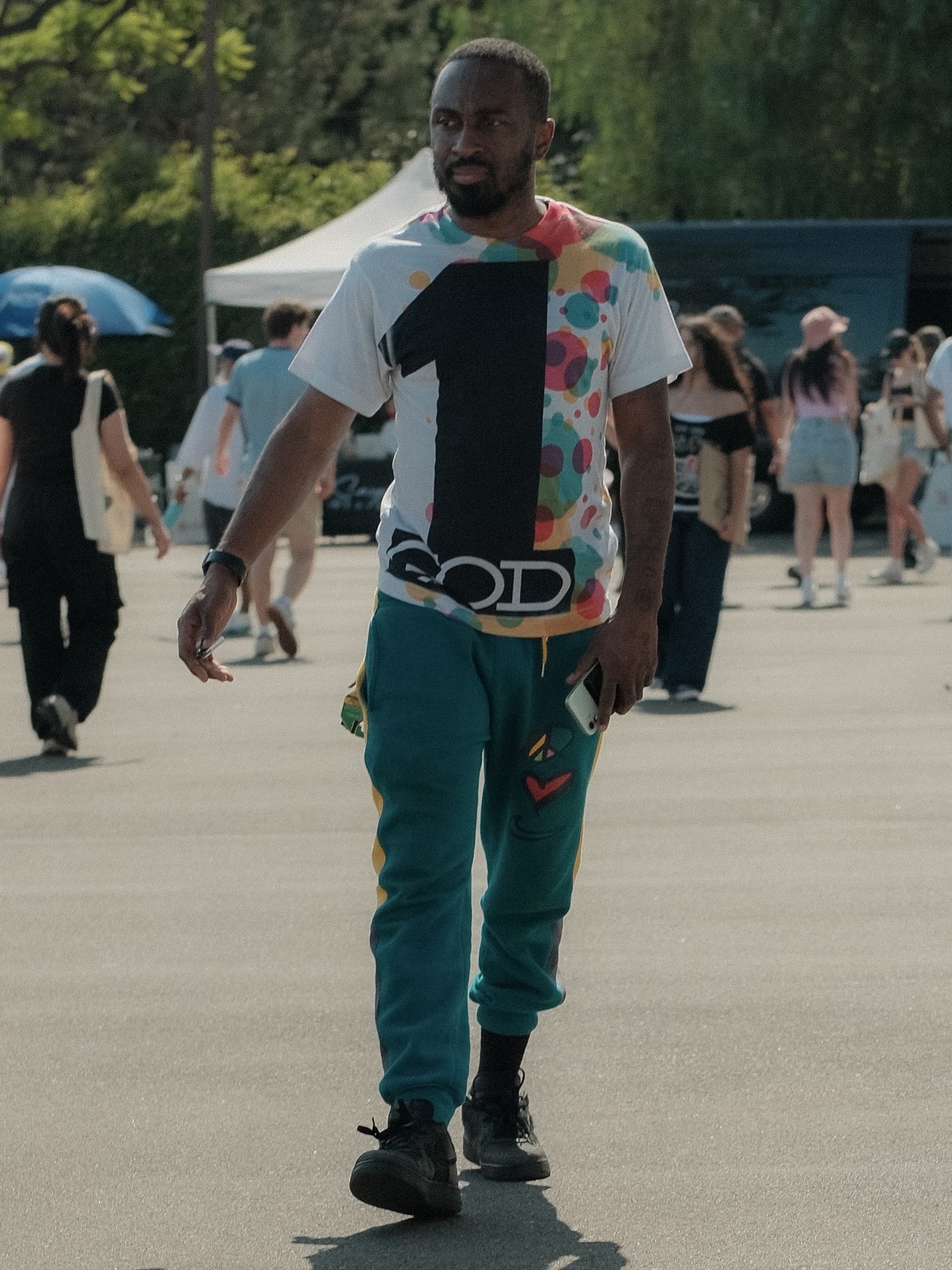 Colorful graphic tee, teal graphic sweatpants, at Spinning Sunset
