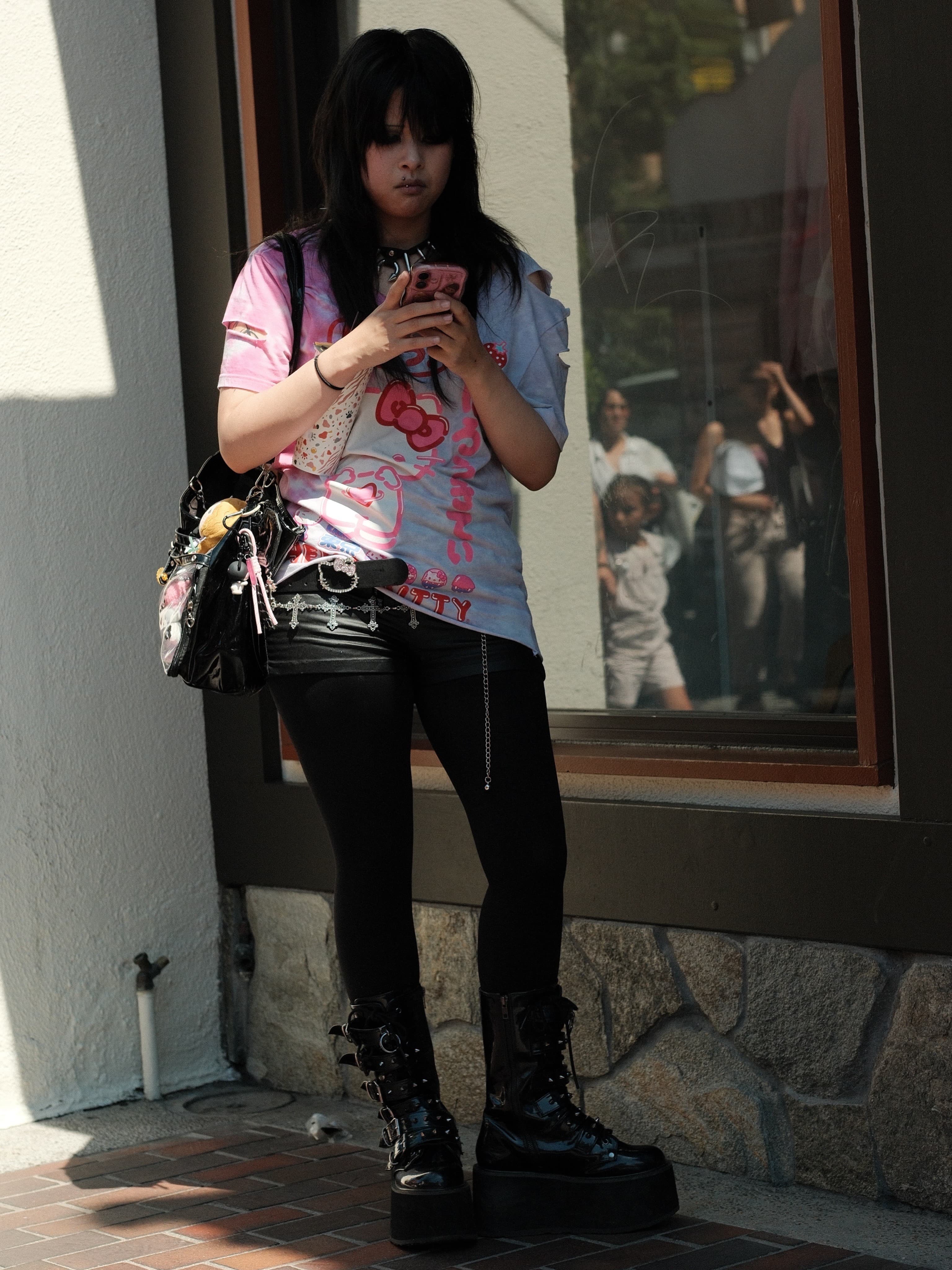 Tie-dye Hello Kitty tee, black shorts, patent platform boots
