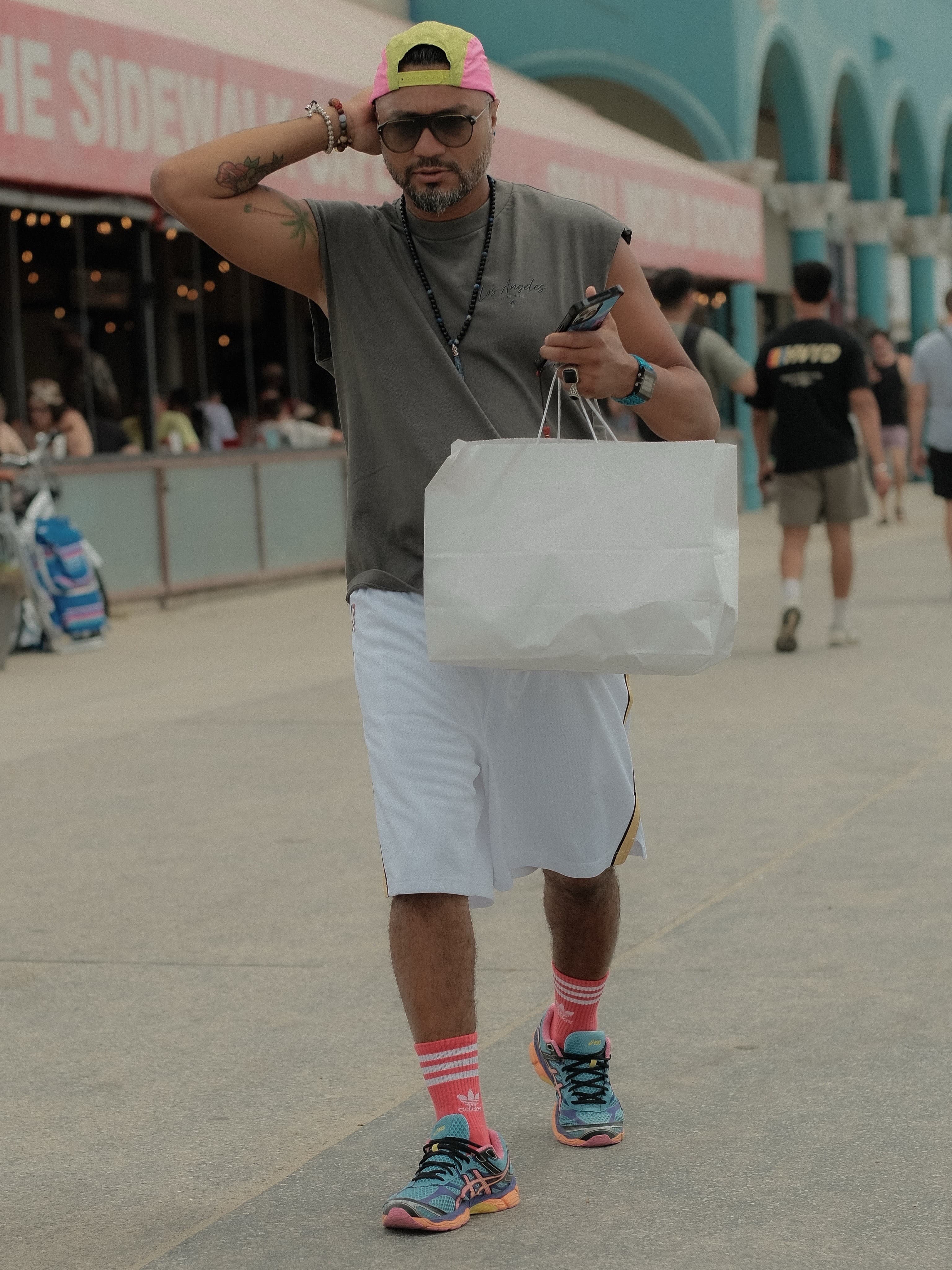 Cutoff sleeve tee, basketball shorts, pink trucker cap