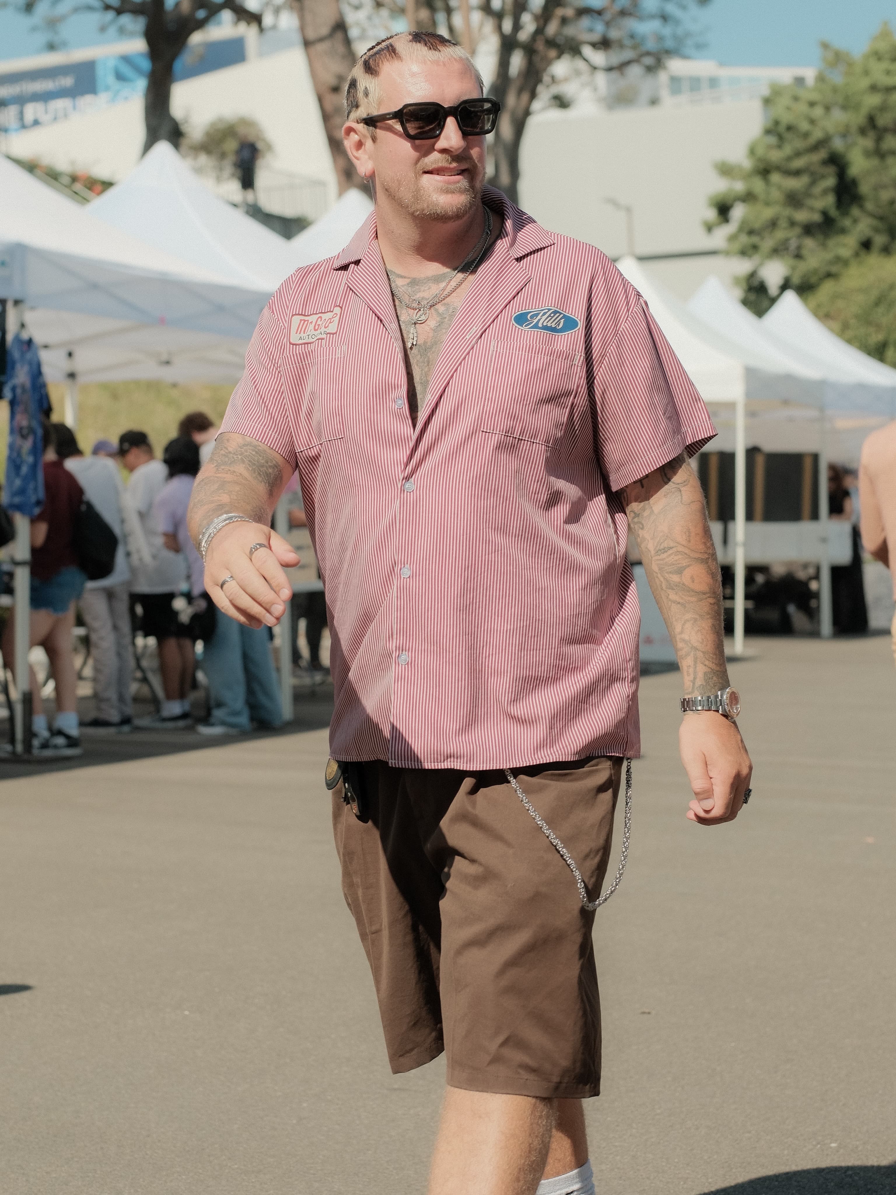 Red-and-white pinstripe bowling shirt, chain wallet, brown shorts, at Spinning Sunset