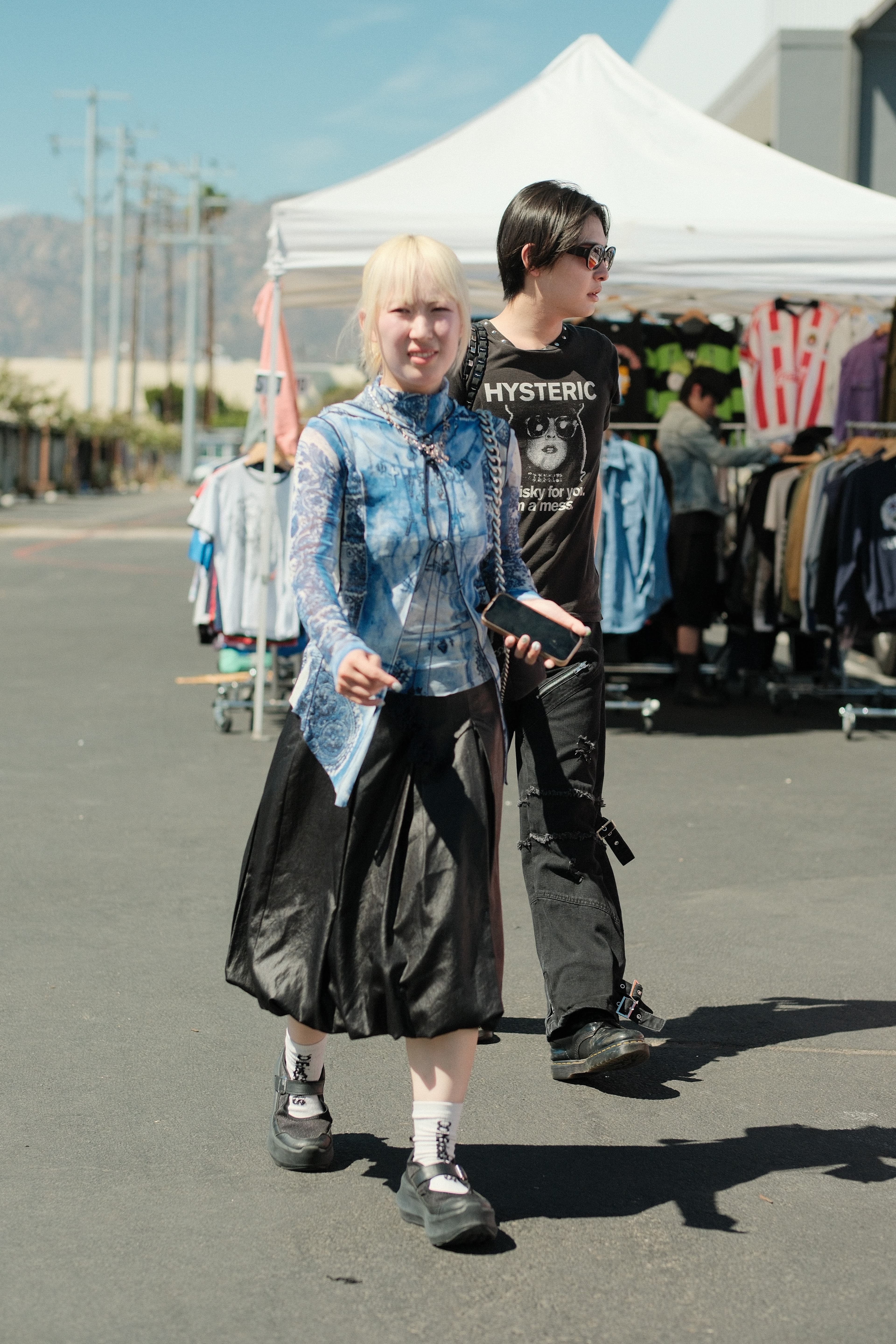 Tie-dye long-sleeve and black leather midi skirt, graphic tee and cargo pants