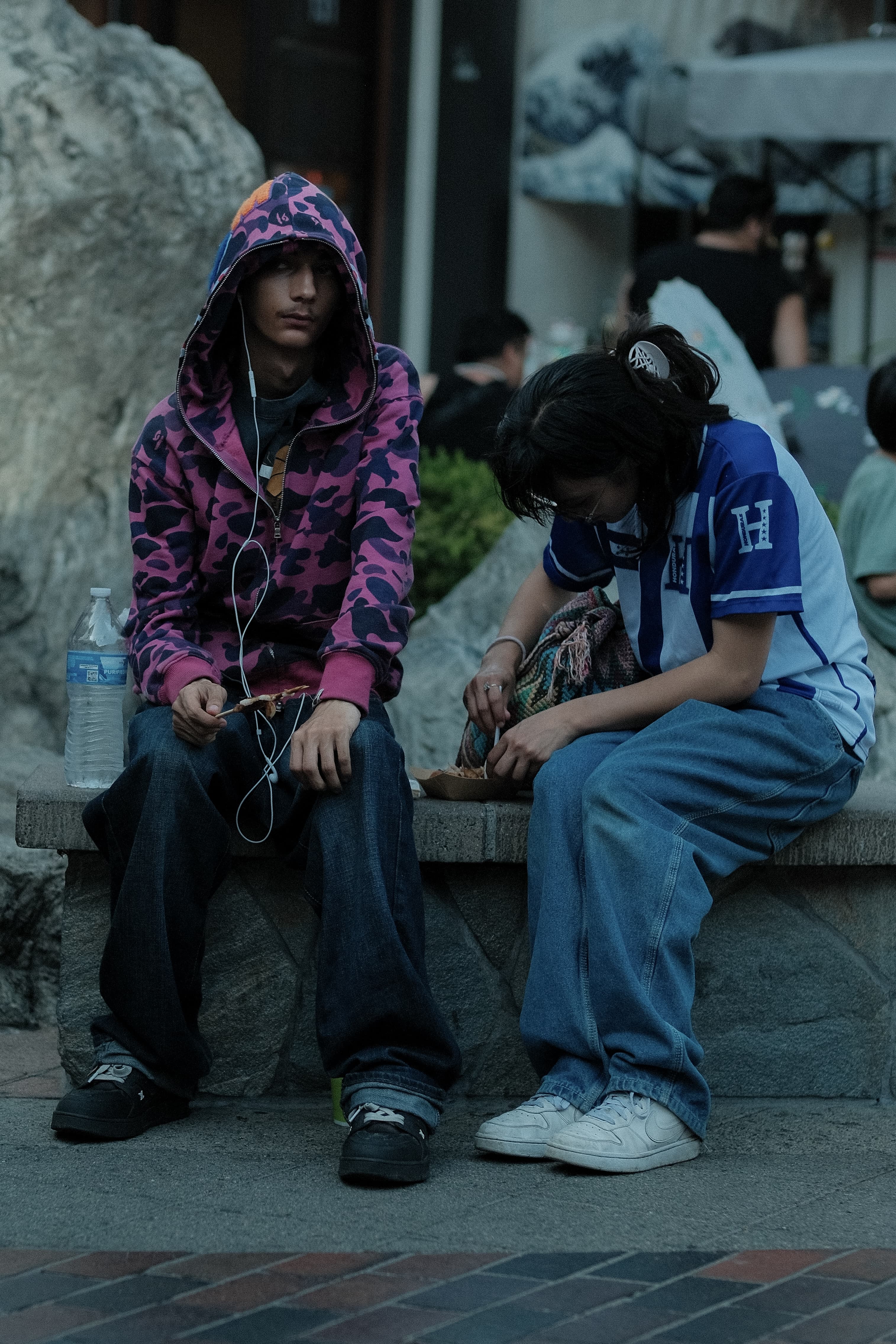 Pink camo zip hoodie, hood up, next to a Honduras soccer jersey