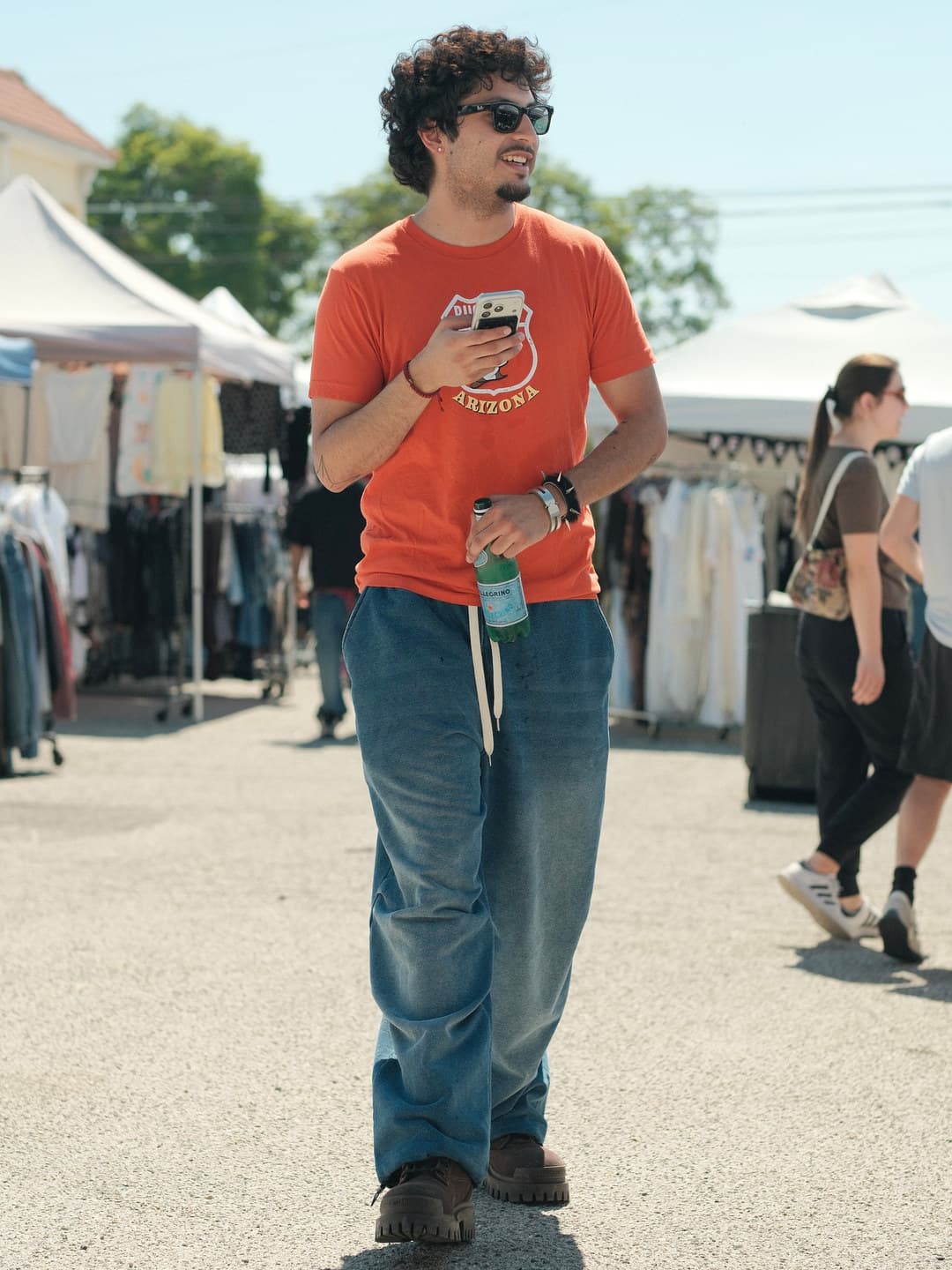 Orange Arizona graphic tee, blue wide-leg corduroy trousers