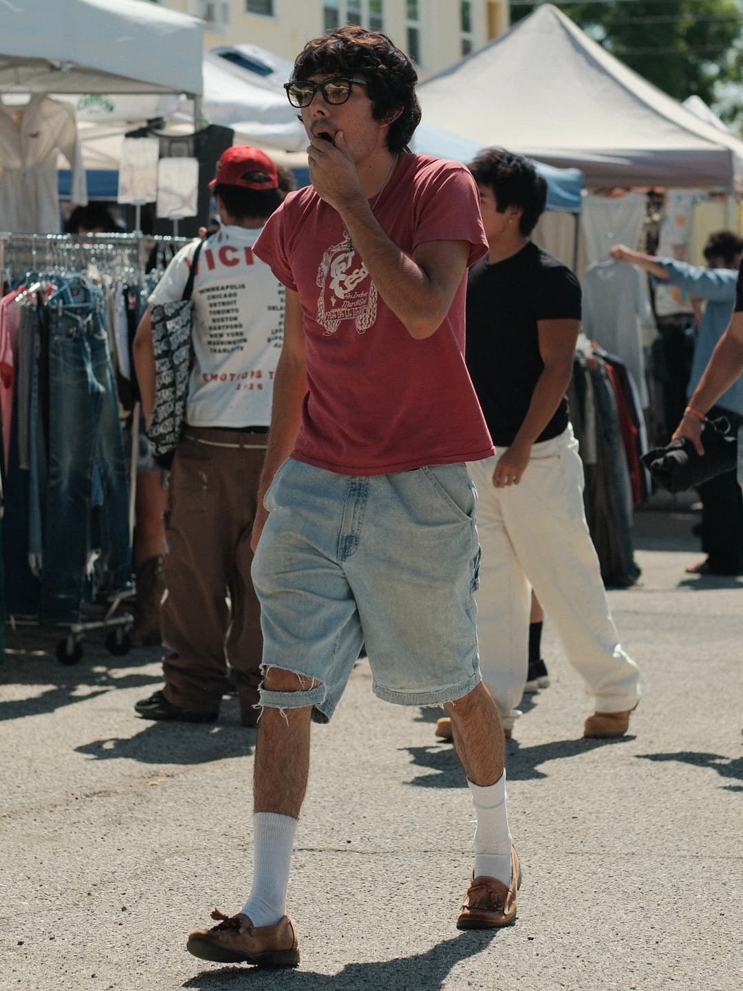 Faded red graphic crew tee, distressed denim carpenter shorts