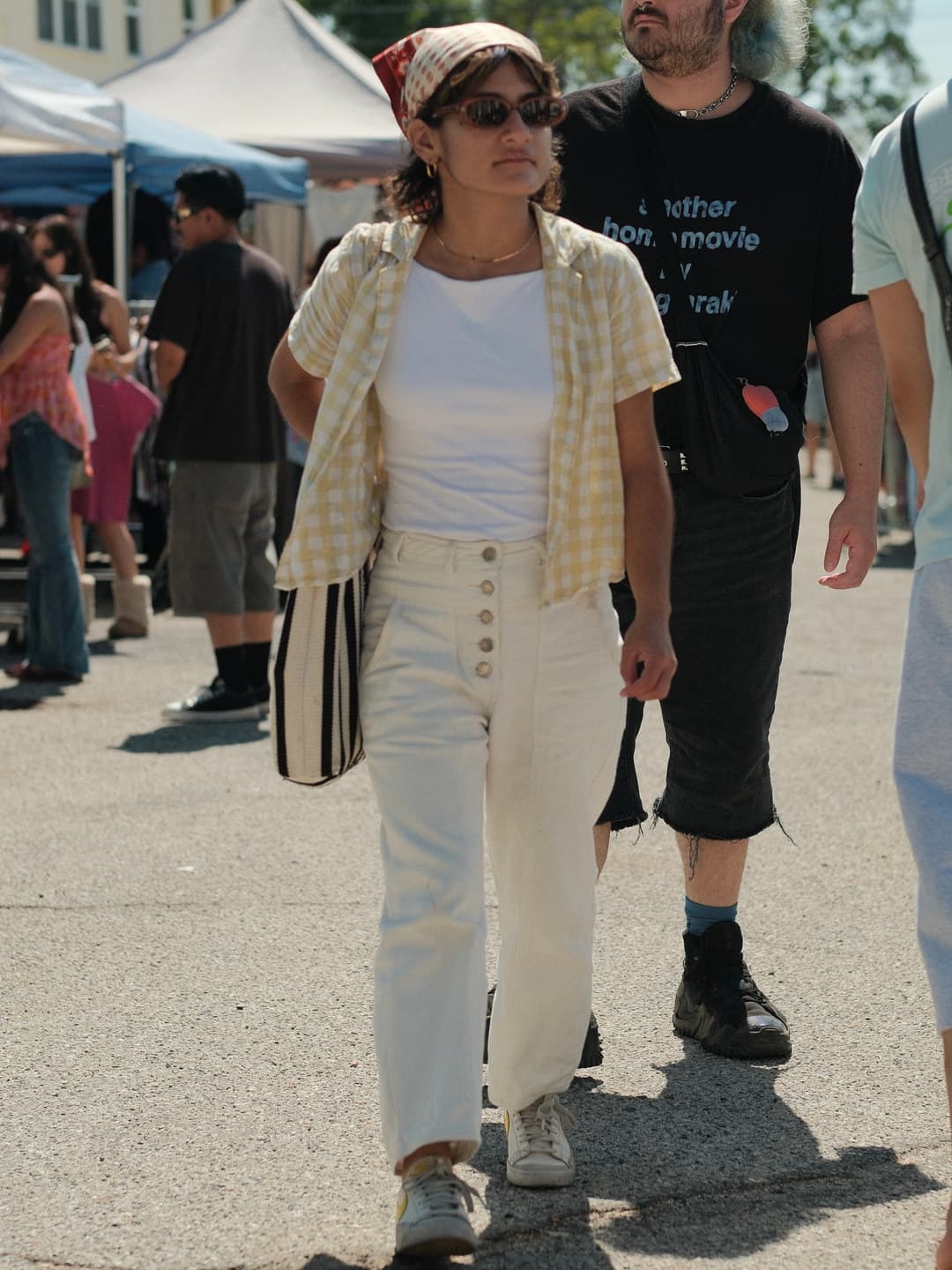 Yellow gingham camp shirt over a white tank, cream high-waisted wide trousers