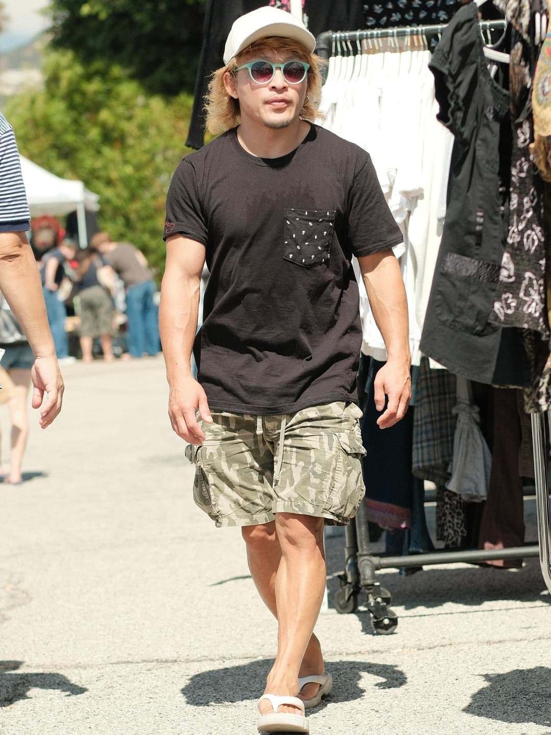 Black tee with a printed paisley chest pocket, camo cargo shorts