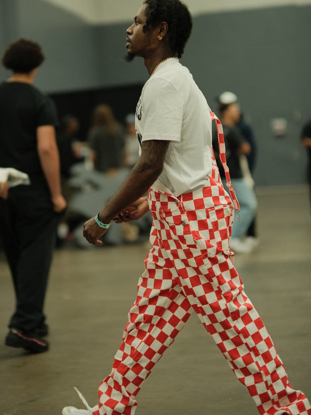White tee, red-and-white checkerboard trousers