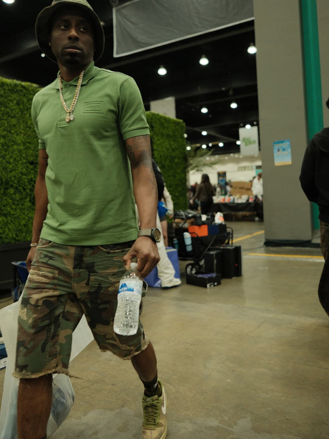 Sage polo, camo cargo shorts, bucket hat