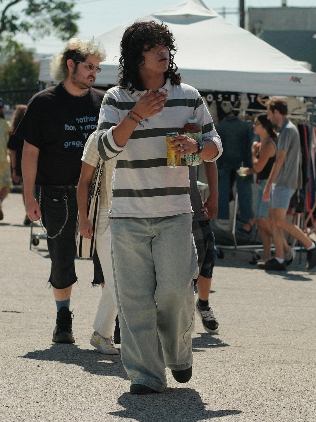 A striped rugby over very wide jeans