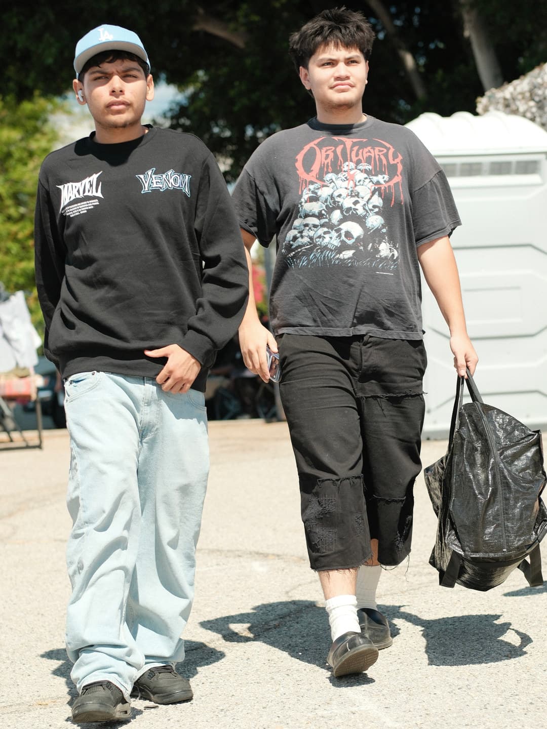 Marvel Venom crewneck and an Obituary band tee with distressed cargo shorts